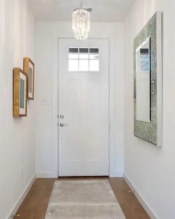 a view of an entryway with wooden floor