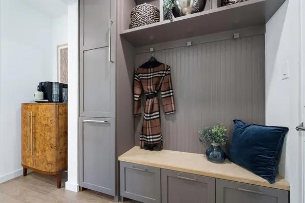 a room with a potted plant and a stove top oven