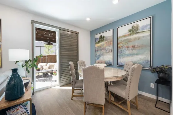 a dining room with furniture and large windows