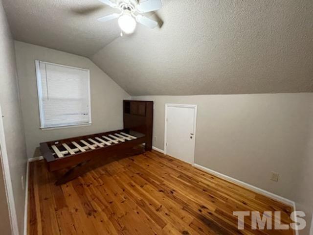 1020 Reca Road Garner, NC 27529 - Photo 13 of 20 a bedroom with a bed and a chandelier
