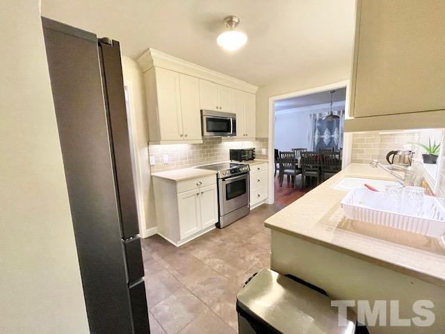 1020 Reca Road Garner, NC 27529 - Photo 5 of 20 a kitchen with stainless steel appliances a sink stove and refrigerator