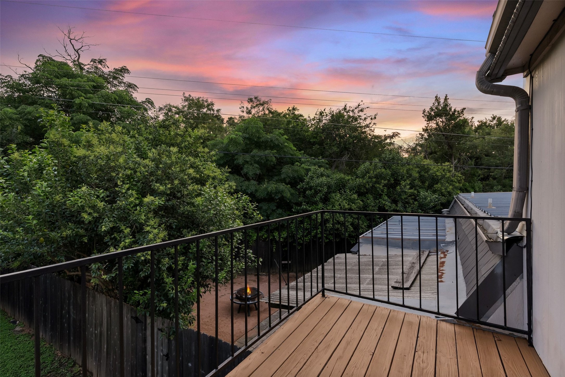 702 Castle Ridge Road, Unit C Austin, TX 78746 - Photo 11 of 36 Upstairs, two spacious bedrooms provide comfortable accommodations. One bedroom includes a walk-in closet, while the second features access to a private balcony.