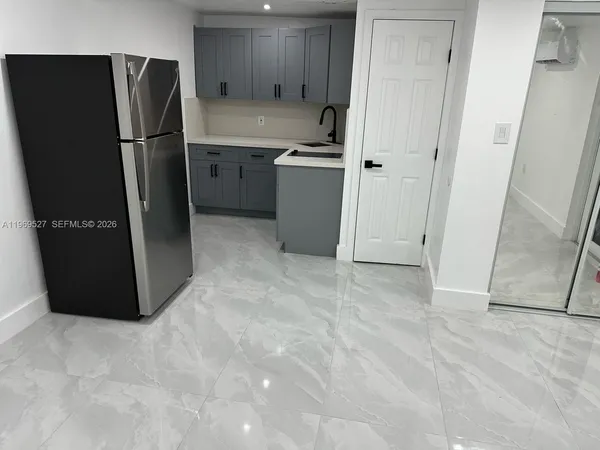 a kitchen with a refrigerator and a sink