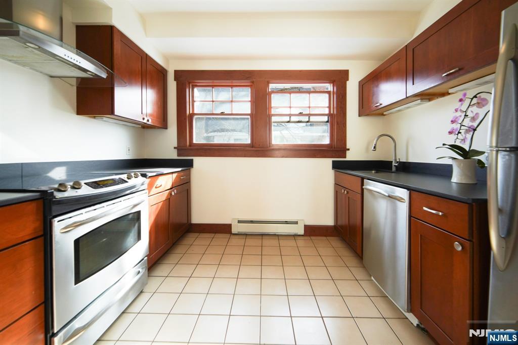 42 Brookfield Road, Unit 2 Montclair, NJ 07043 - Photo 13 of 36 a kitchen with stainless steel appliances granite countertop a stove a sink and a microwave