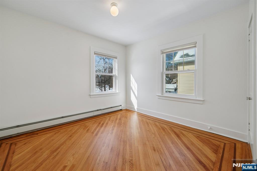 42 Brookfield Road, Unit 2 Montclair, NJ 07043 - Photo 22 of 36 an empty room with wooden floor and windows