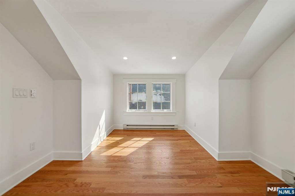 42 Brookfield Road, Unit 2 Montclair, NJ 07043 - Photo 36 of 36 a view of an empty room with wooden floor and a window