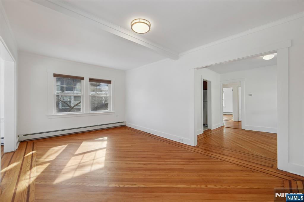 42 Brookfield Road, Unit 2 Montclair, NJ 07043 - Photo 7 of 36 a view of empty room with window and wooden floor