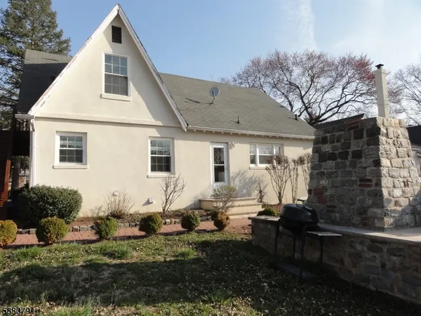 a backyard of a house with yard fire pit and outdoor seating