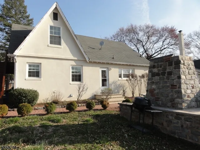 a backyard of a house with yard fire pit and outdoor seating