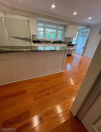 a kitchen with stainless steel appliances granite countertop a sink and cabinets