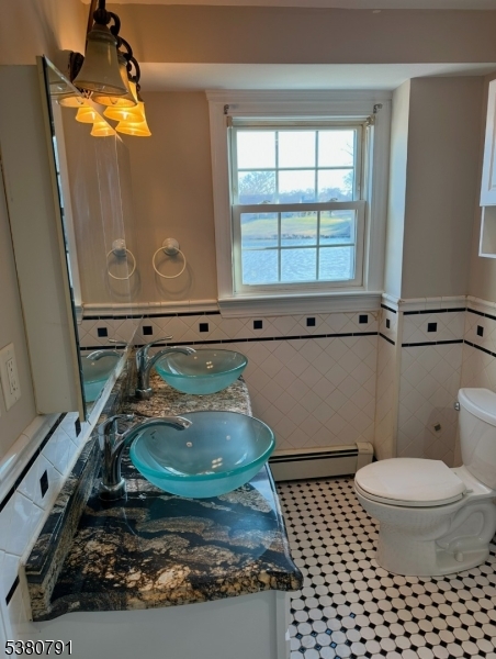 45 Lakeside Drive South Piscataway, NJ 08854 - Photo 5 of 8 a bathroom with a sink a toilet and a mirror