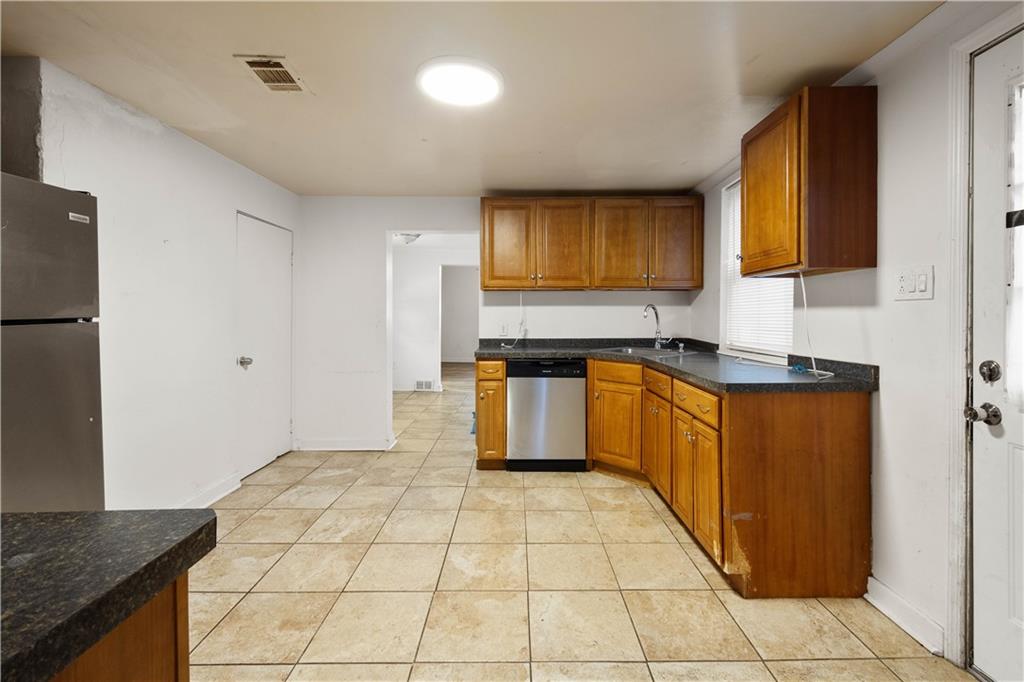 108 Pius Street Pittsburgh, PA 15203 - Photo 17 of 35 a kitchen with stainless steel appliances granite countertop a sink stove and refrigerator