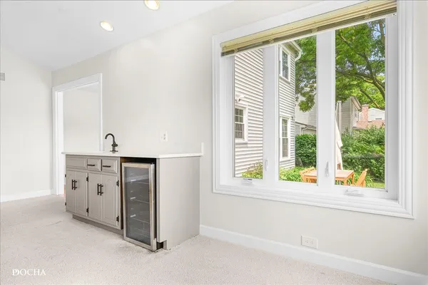 a kitchen with white cabinets and sink