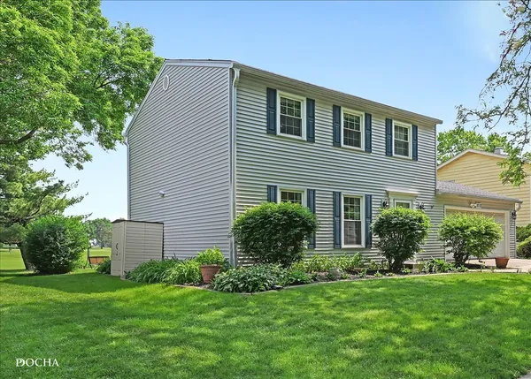 a view of a house with a yard and sitting area