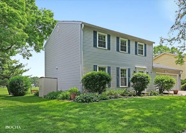 a view of a house with a yard and sitting area