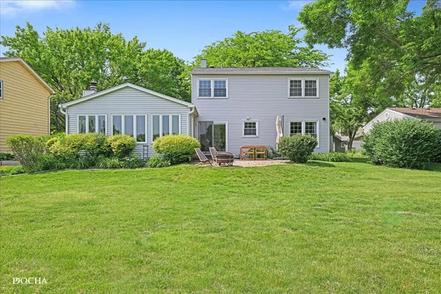 a view of a house with a yard and sitting area