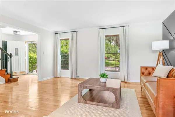 a living room with a table and a chandelier