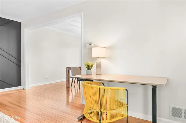 a living room with kitchen island furniture and a chandelier