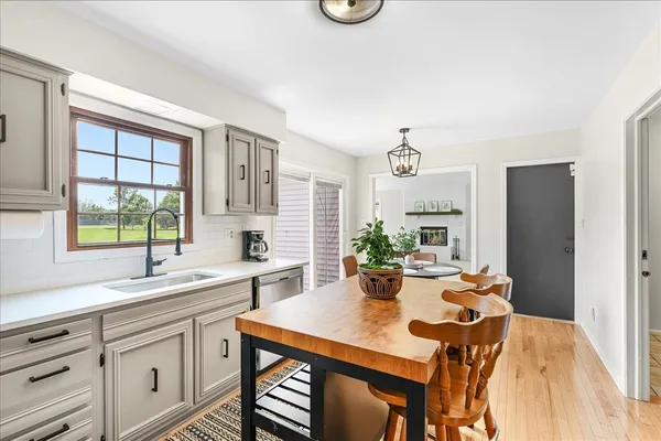 a view of a dining room with furniture and a window