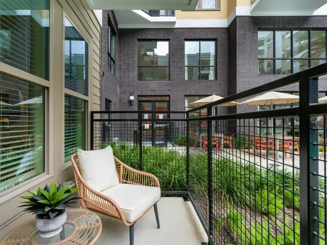 a kitchen with stainless steel appliances a refrigerator a stove top oven a sink dishwasher and white cabinets with wooden floor