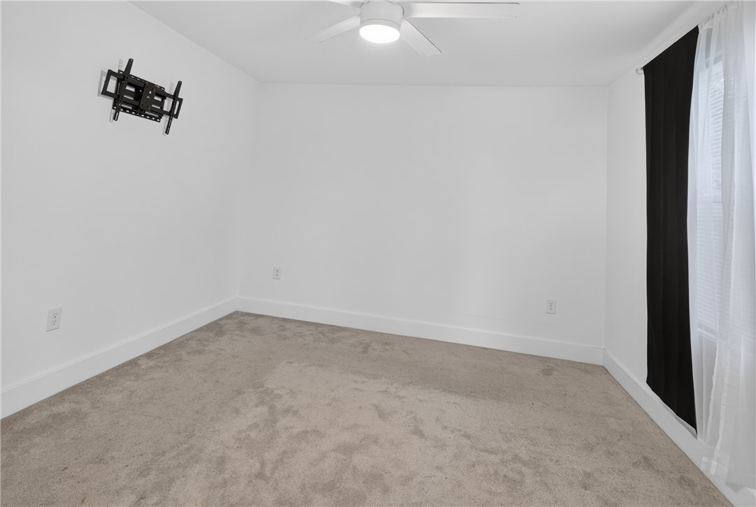 115 Pelfrey Street Seneca, SC 29672 - Photo 25 of 46 Well-lit sleeping quarters featuring soft carpet and a modern ceiling fan.