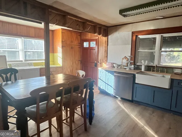 a dining room with a wooden table and chairs