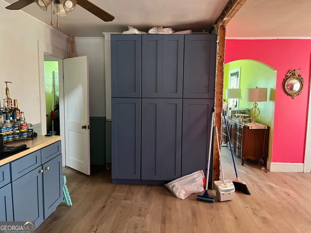 a kitchen with stainless steel appliances granite countertop a refrigerator and a wooden floor