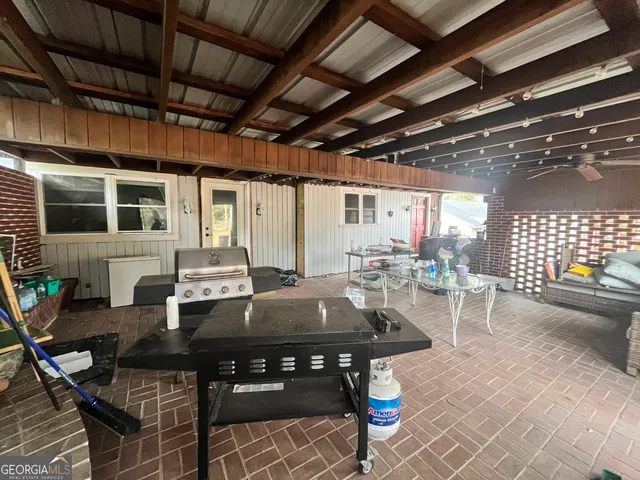 a view of a dinning table and chairs in the patio