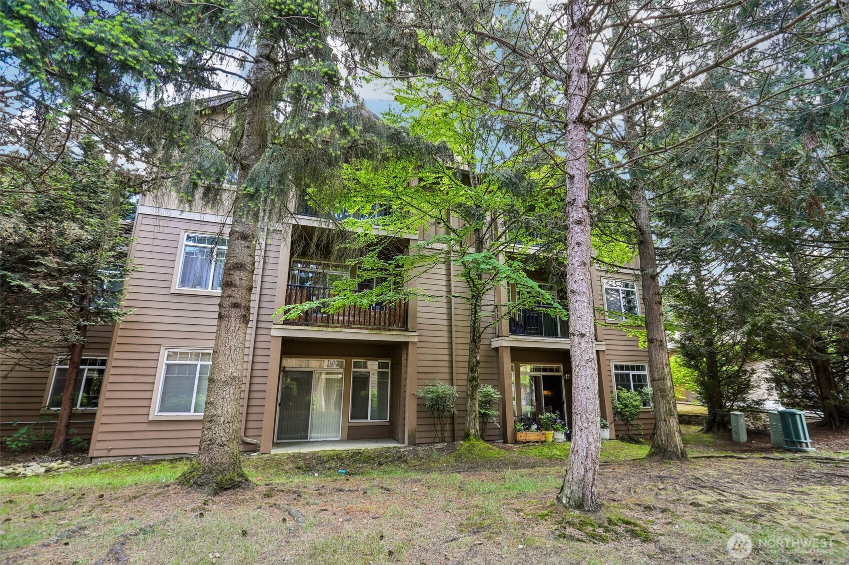 18930 Bothell Everett Highway, Unit E301 Bothell, WA 98012 - Photo 25 of 28 a front view of a house with a yard