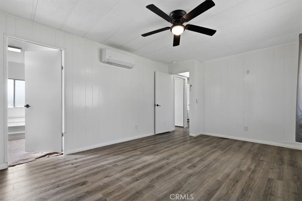 5405 Marjorie Street Weldon, CA 93283 - Photo 11 of 36 an empty room with wooden floor and a ceiling fan
