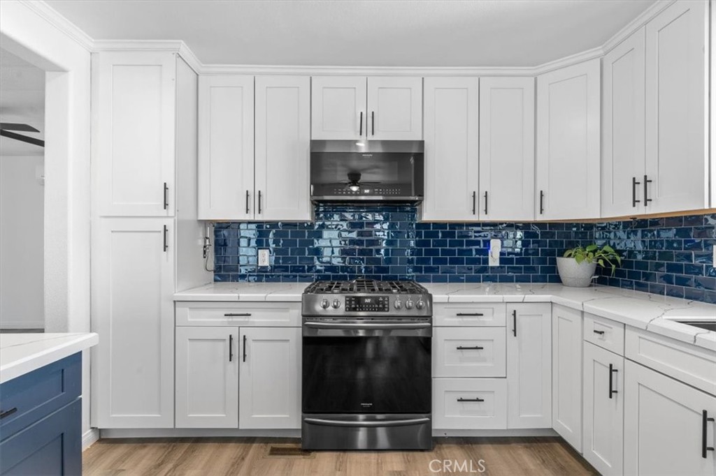 5405 Marjorie Street Weldon, CA 93283 - Photo 17 of 36 a kitchen with white cabinets and appliances