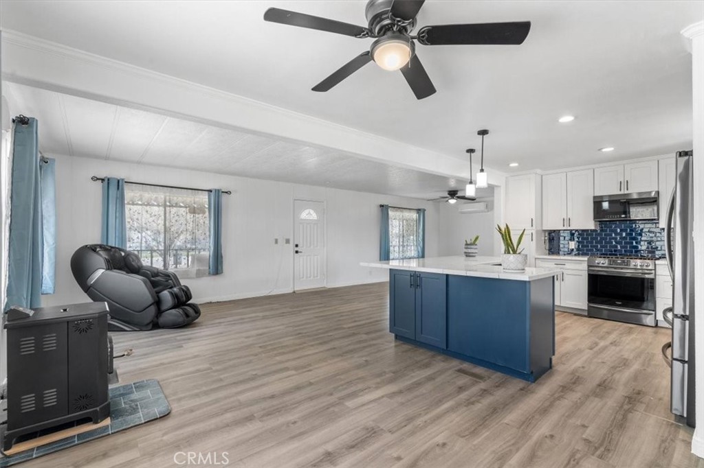 5405 Marjorie Street Weldon, CA 93283 - Photo 18 of 36 a kitchen with kitchen island a counter space a sink appliances and cabinets
