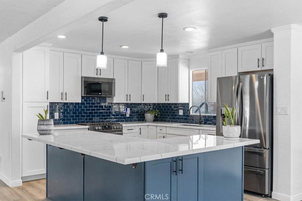 5405 Marjorie Street Weldon, CA 93283 - Photo 19 of 36 a kitchen with stainless steel appliances a sink a stove a refrigerator and cabinets