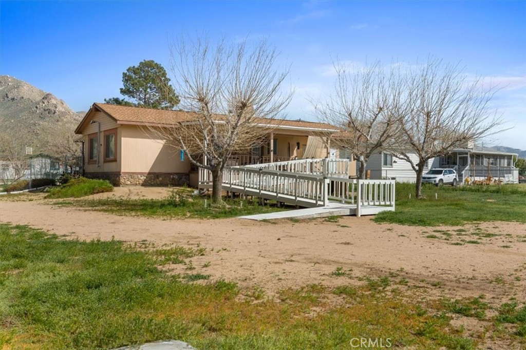 5405 Marjorie Street Weldon, CA 93283 - Photo 24 of 36 a front view of a house with a yard and garage