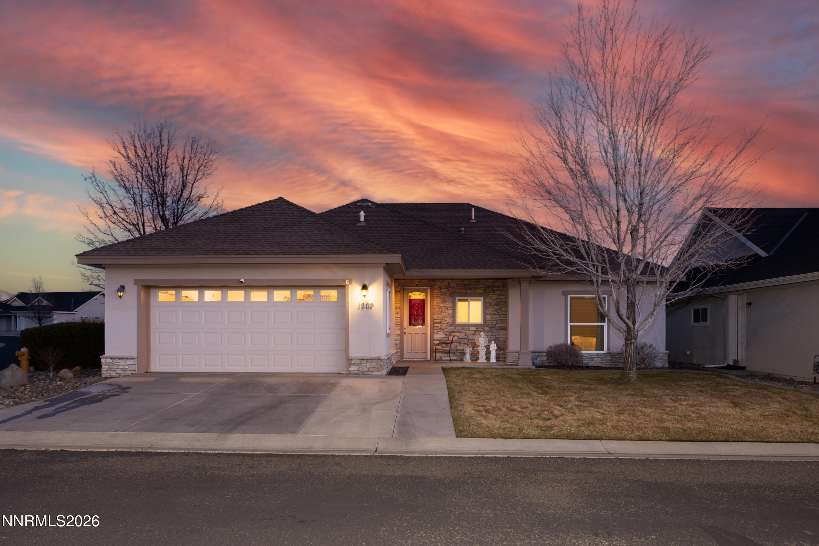 a view of a house with a yard and garage