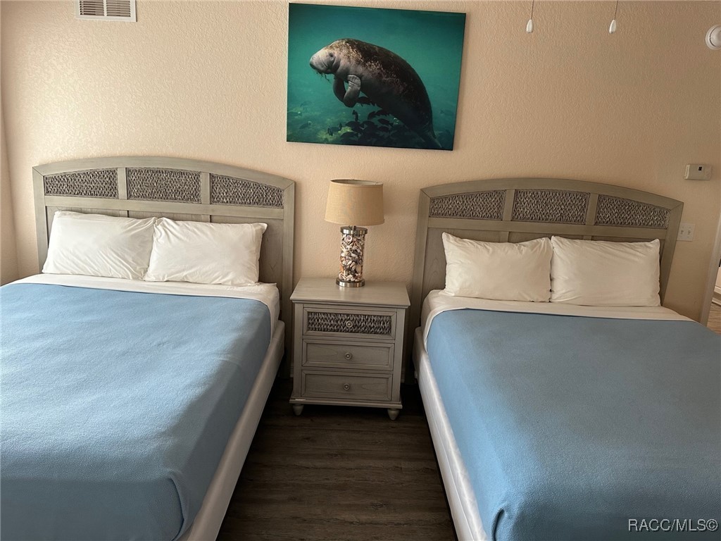 5291 South Cherokee Way Homosassa, FL 34448 - Photo 17 of 27 a bedroom with a bed and a painting on the wall