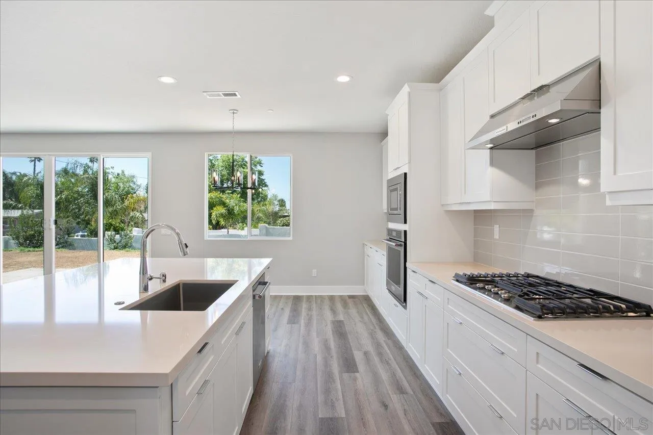 311 Brotherton Road Escondido, CA 92025 - Photo 12 of 33 a kitchen with kitchen island granite countertop a stove and a sink with granite countertops