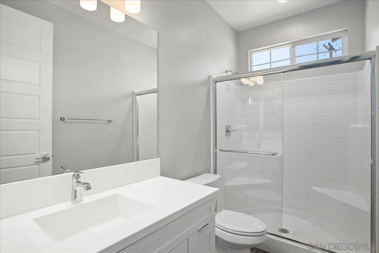 311 Brotherton Road Escondido, CA 92025 - Photo 16 of 33 a bathroom with a sink a toilet and shower