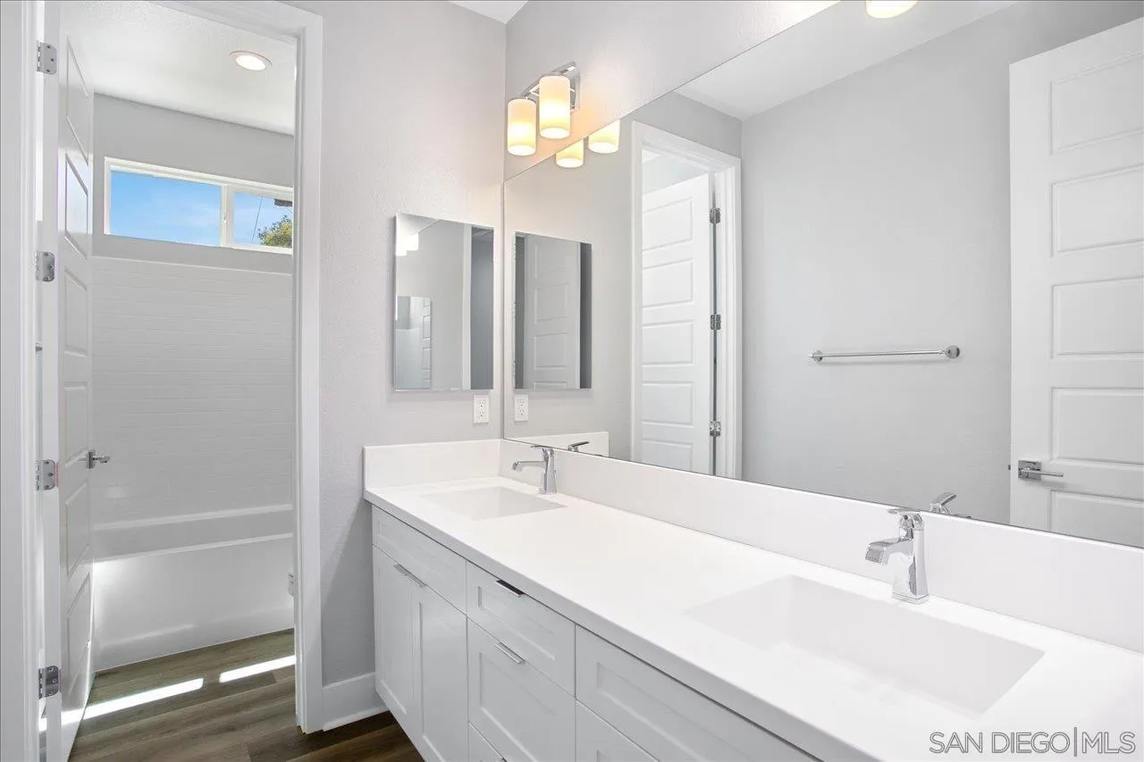311 Brotherton Road Escondido, CA 92025 - Photo 18 of 33 a bathroom with a bathtub a sink and a mirror
