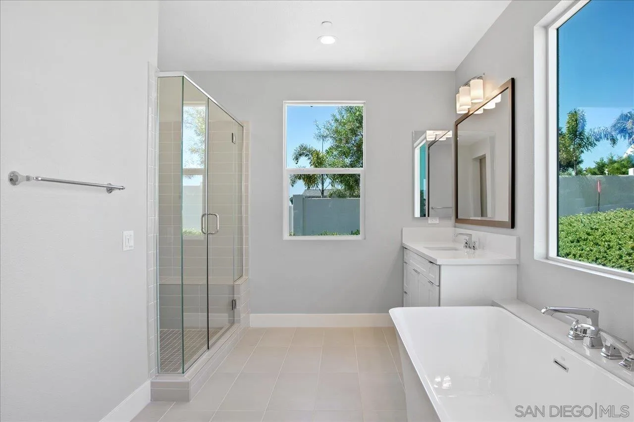 311 Brotherton Road Escondido, CA 92025 - Photo 22 of 33 a bathroom with a tub sink and mirror