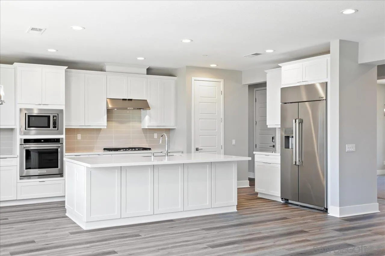 311 Brotherton Road Escondido, CA 92025 - Photo 6 of 33 a kitchen with stainless steel appliances a refrigerator and a stove top oven