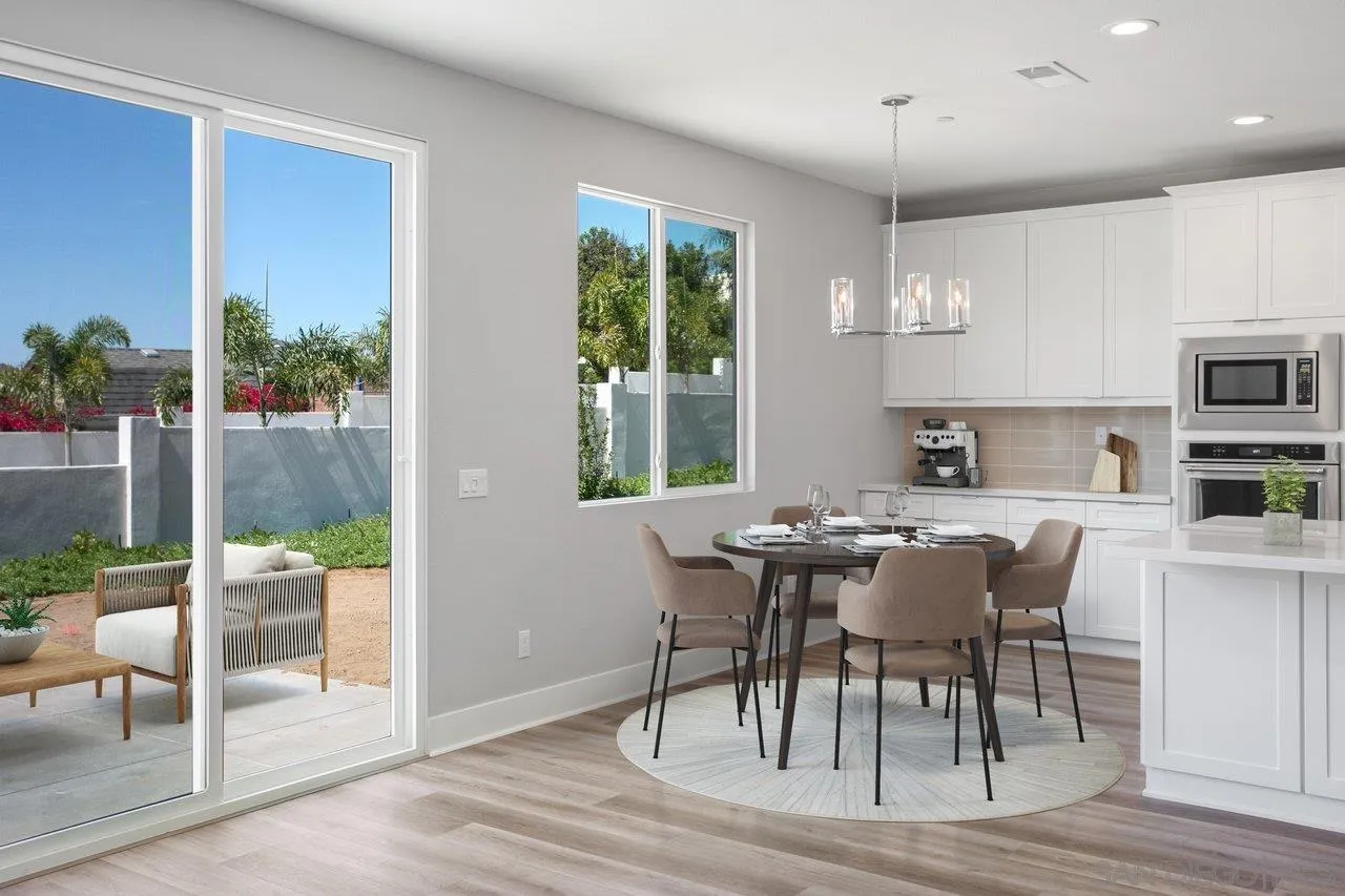 311 Brotherton Road Escondido, CA 92025 - Photo 7 of 33 a view of a dining room with furniture window and wooden floor