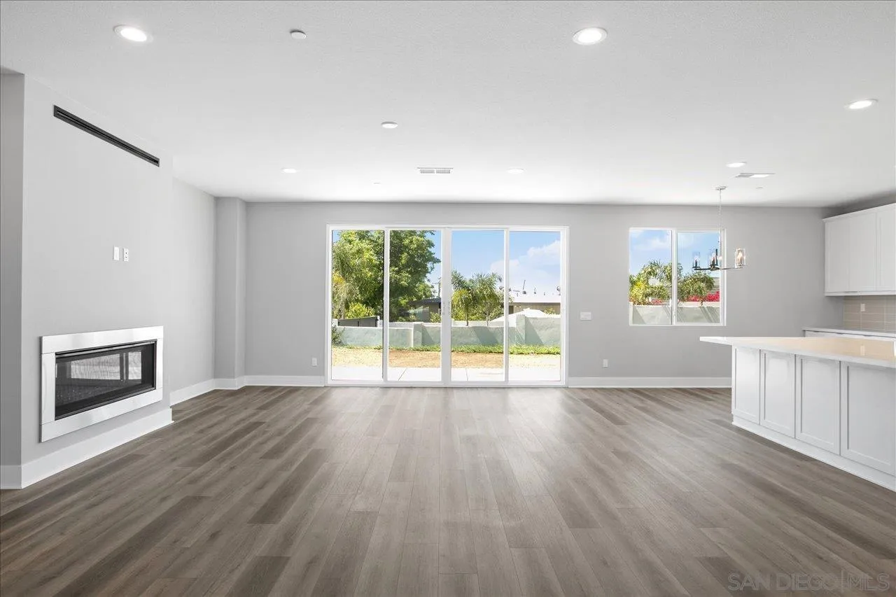 311 Brotherton Road Escondido, CA 92025 - Photo 9 of 33 a view of an empty room with a window and wooden floor