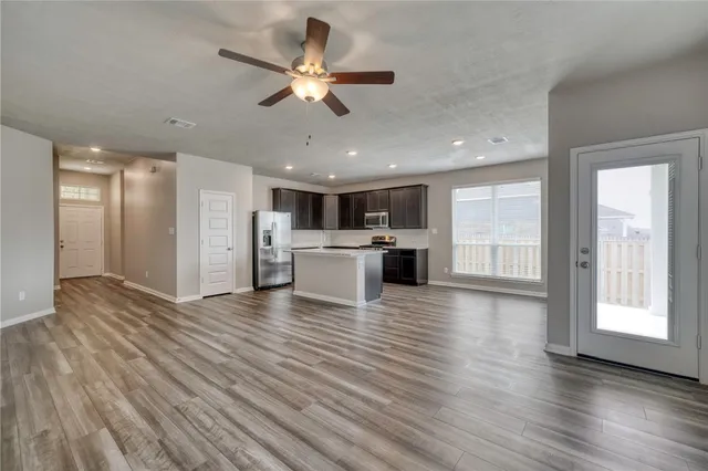 a view of a kitchen with a stove cabinets and wooden floor