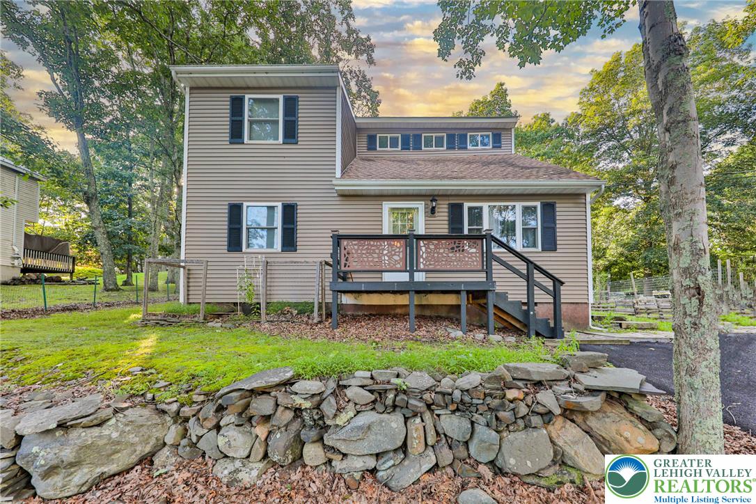 2114 Lakeview Road Bushkill, PA 18324 - Photo 1 of 83 Classic siding and an elevated entry deck create character beneath a canopy of mature trees.