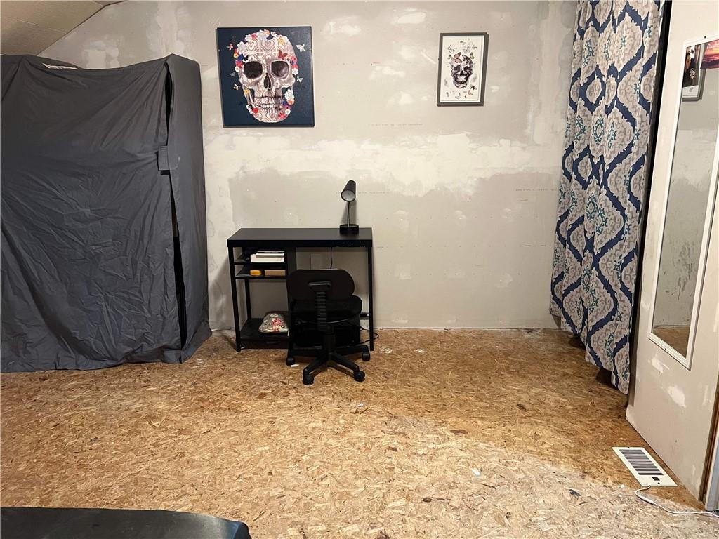 585 Lone Pine Road Washington, PA 15301 - Photo 17 of 22 a view of an empty room with wooden floor and a cabinet