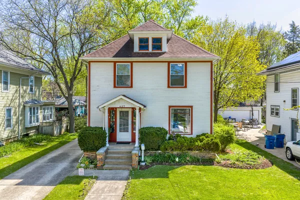 a front view of house with yard and green space