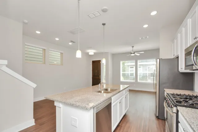 a bathroom with a granite countertop sink a large mirror and a shower