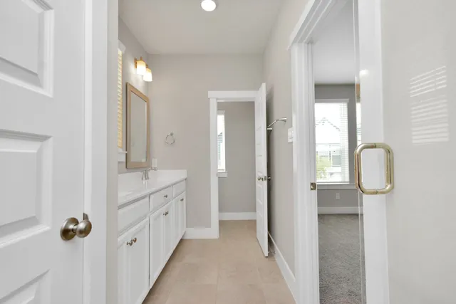 a bathroom with a double vanity sink and mirror