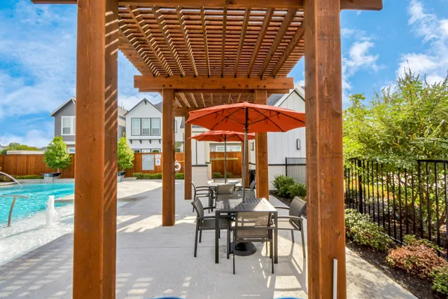 a view of a patio with a table and chairs and potted plants